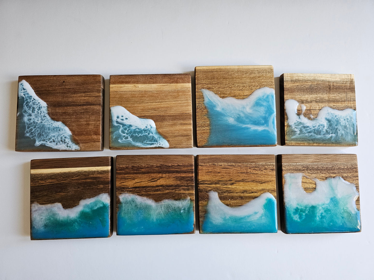 Wooden coasters with a resin ocean wave design